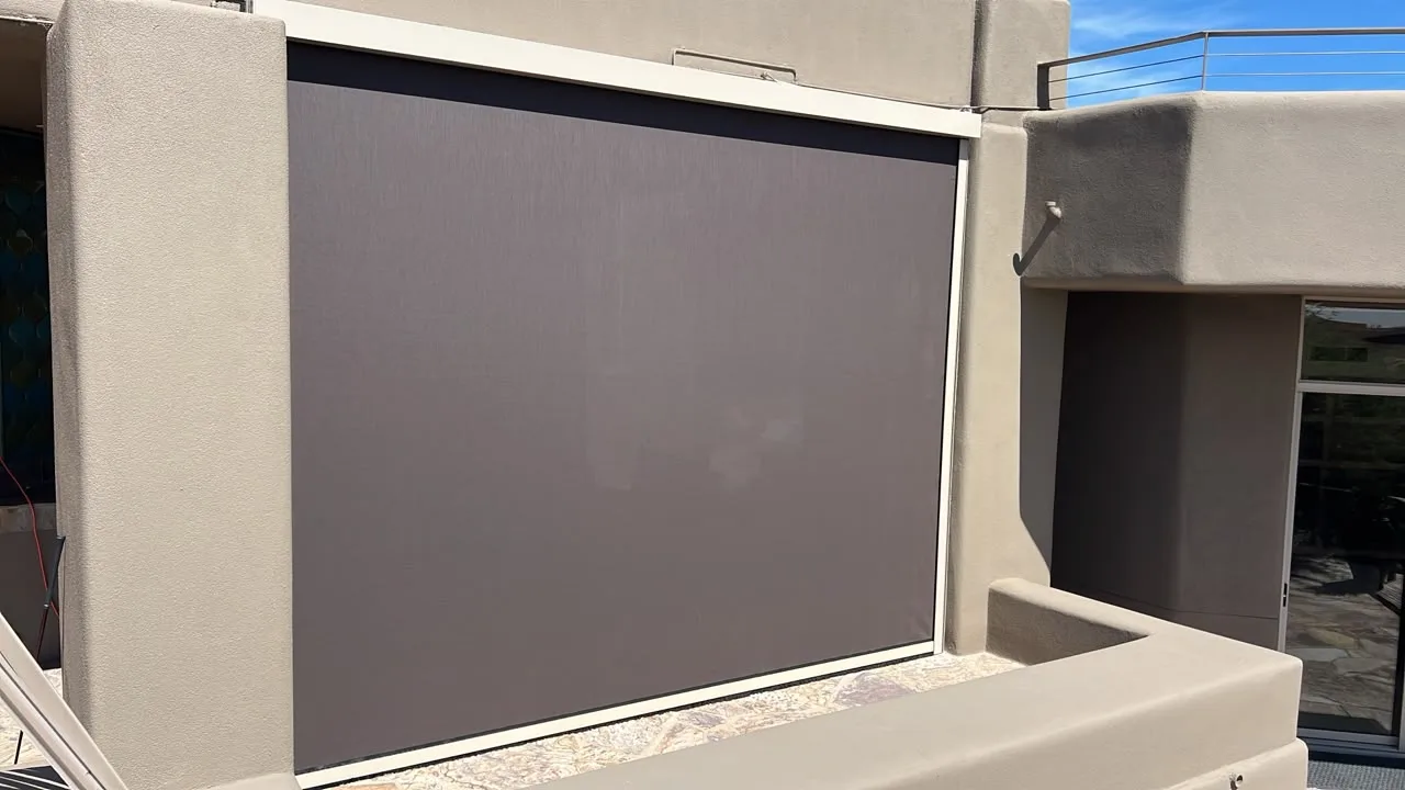 Exterior retractable shades lowered along a covered back patio